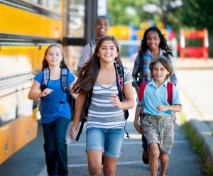 School safety makes kids smiling walking to school.