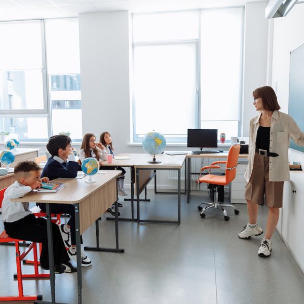 Teacher stands before classroom